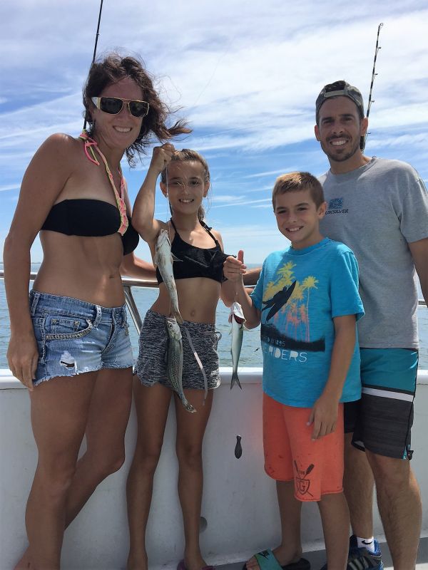 family holding their recent catches