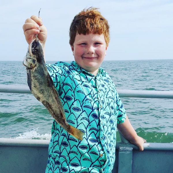 little boy holding his recent catch