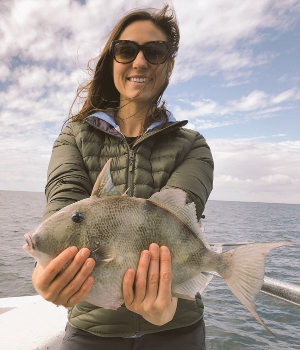 woman-holding-recently-caught-fish