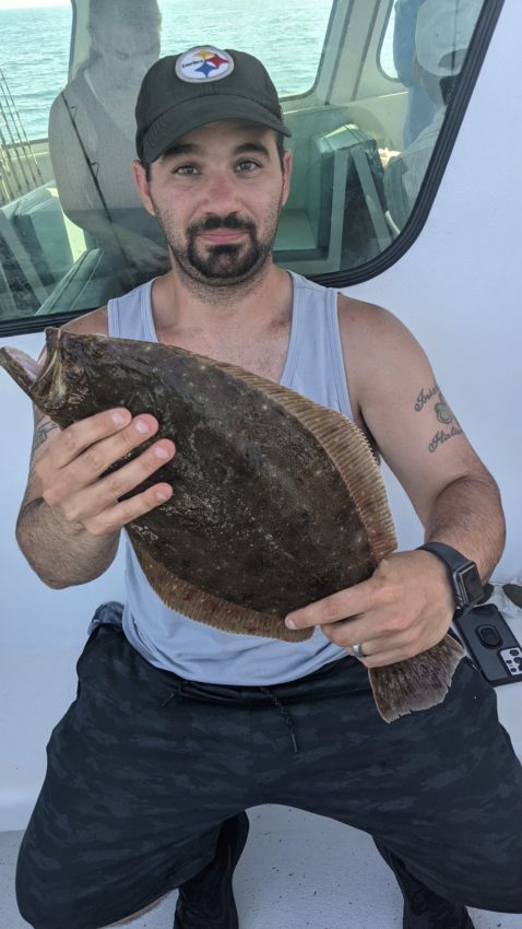 Man holding up a large fish